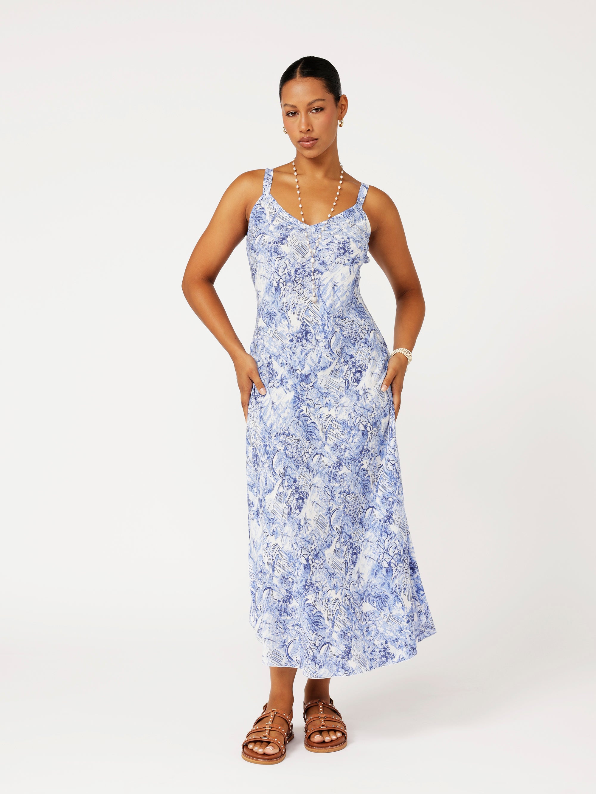 Model wearing the Lost City Slip Dress in blue Toile de Jouy rayon print.”