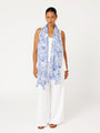 Front view of model wearing Lost City Blue Toile de Jouy rayon scarf draped loosely over white outfit