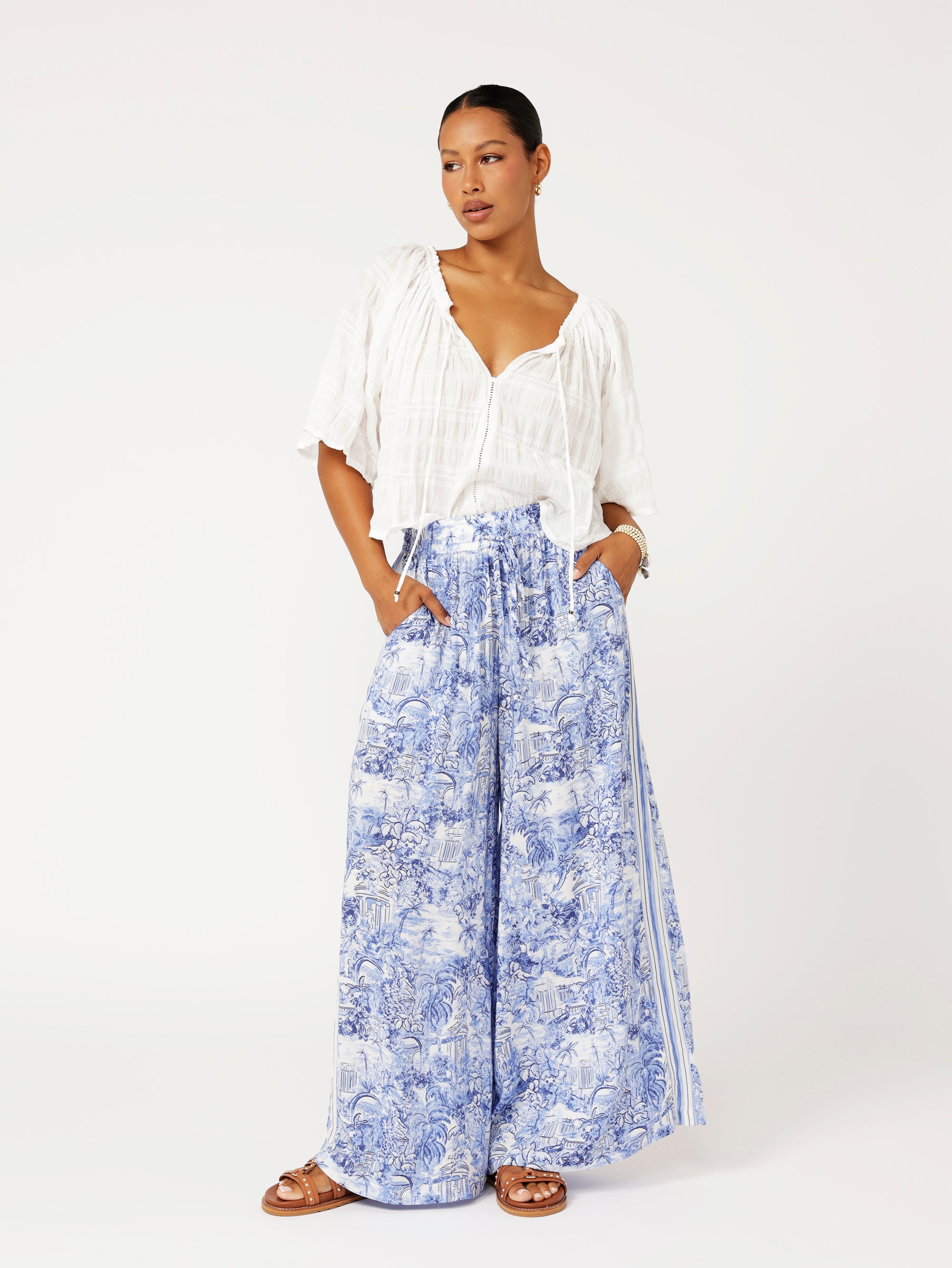 Styled look featuring the Lost City Palazzo Pants with white blouse for fresh resort style