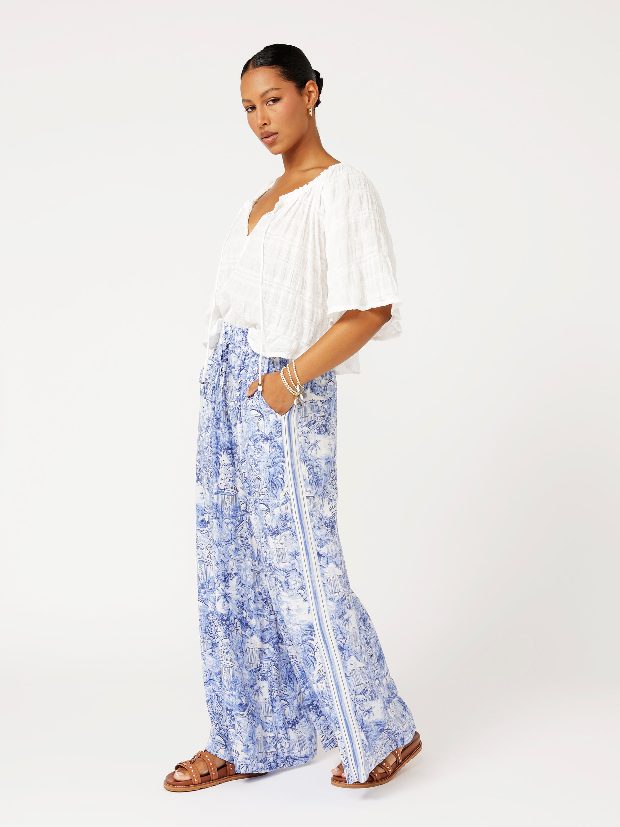 Styled look featuring the Lost City Palazzo Pants with white blouse for fresh resort style