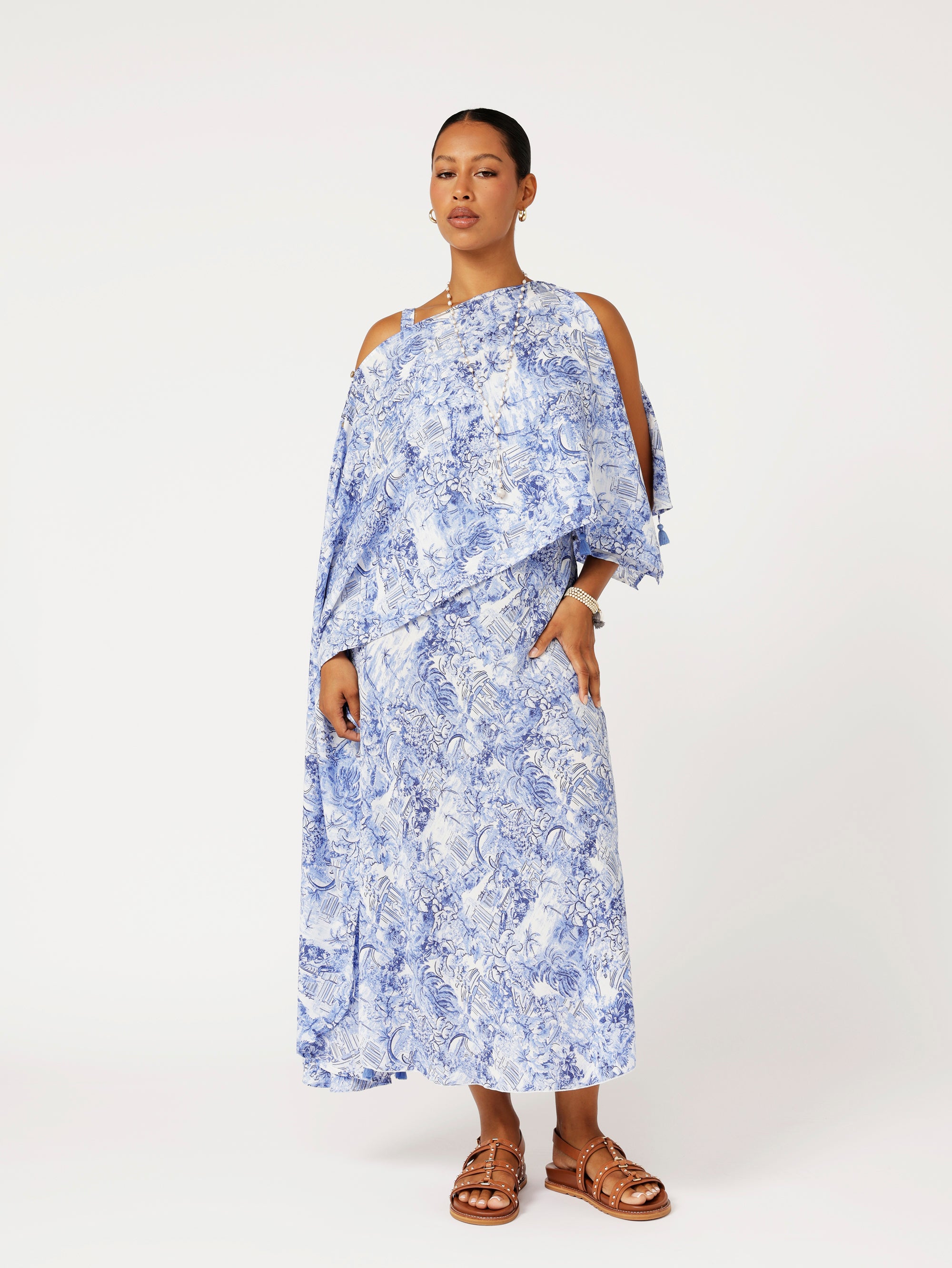 Front view of model wearing Soiree Wrap in blue Toile de Jouy rayon print styled over matching Slip Dress for evening resort look