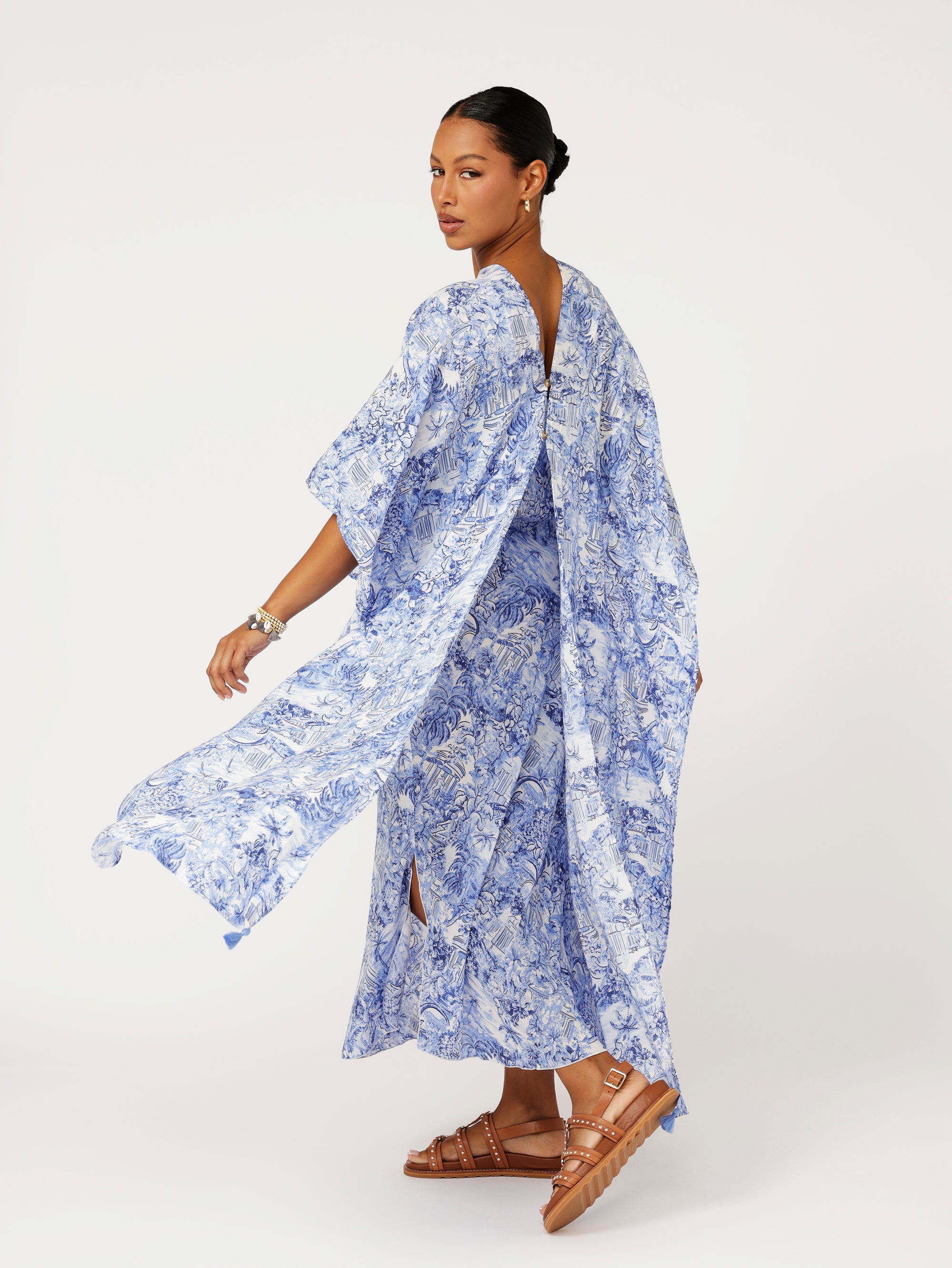 Back view of model wearing blue Toile de Jouy Soiree Wrap with relaxed drape and V-back detail.