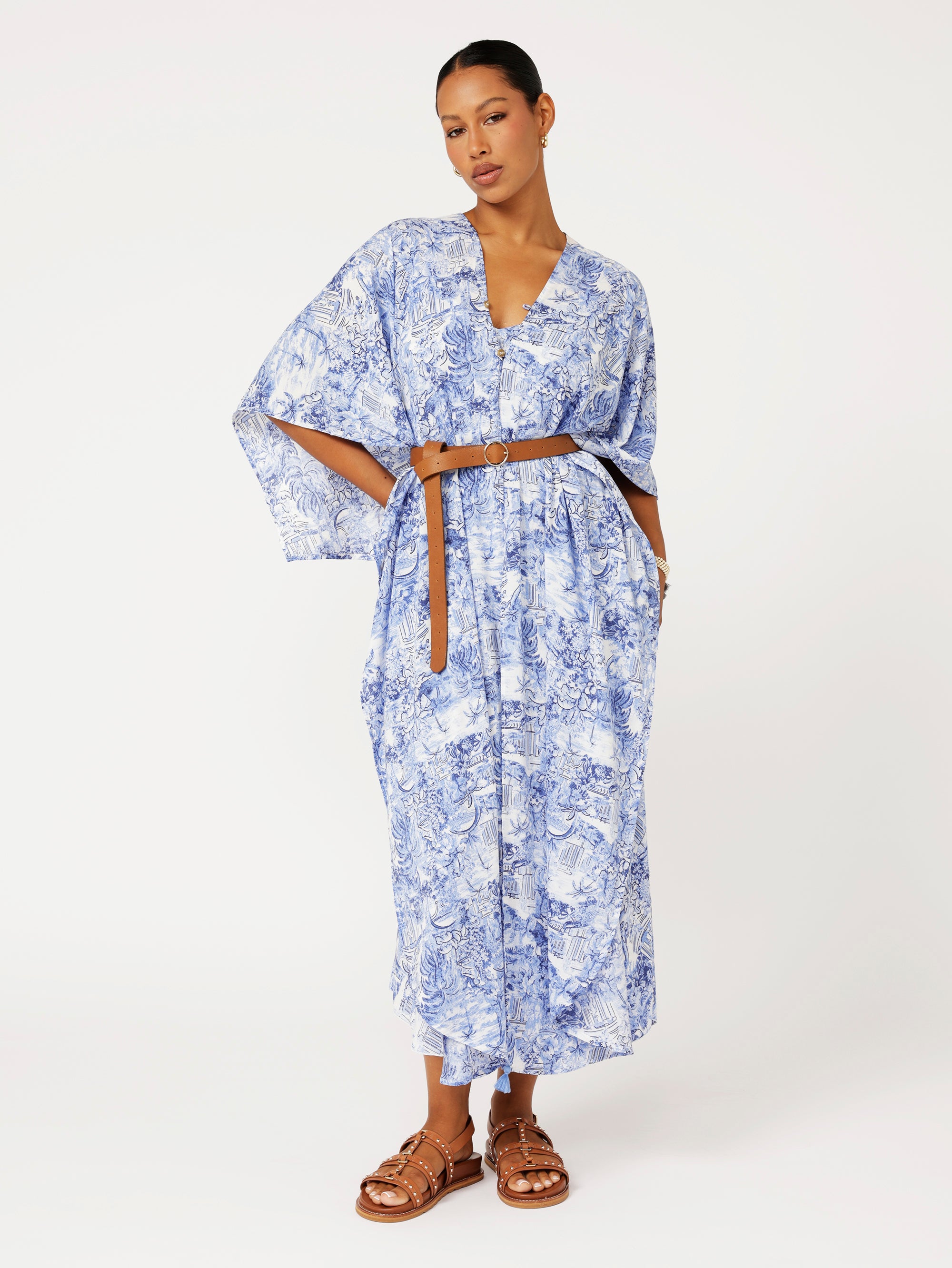Soiree Wrap in blue Toile de Jouy print styled with belt for chic resort wear and summer event look.