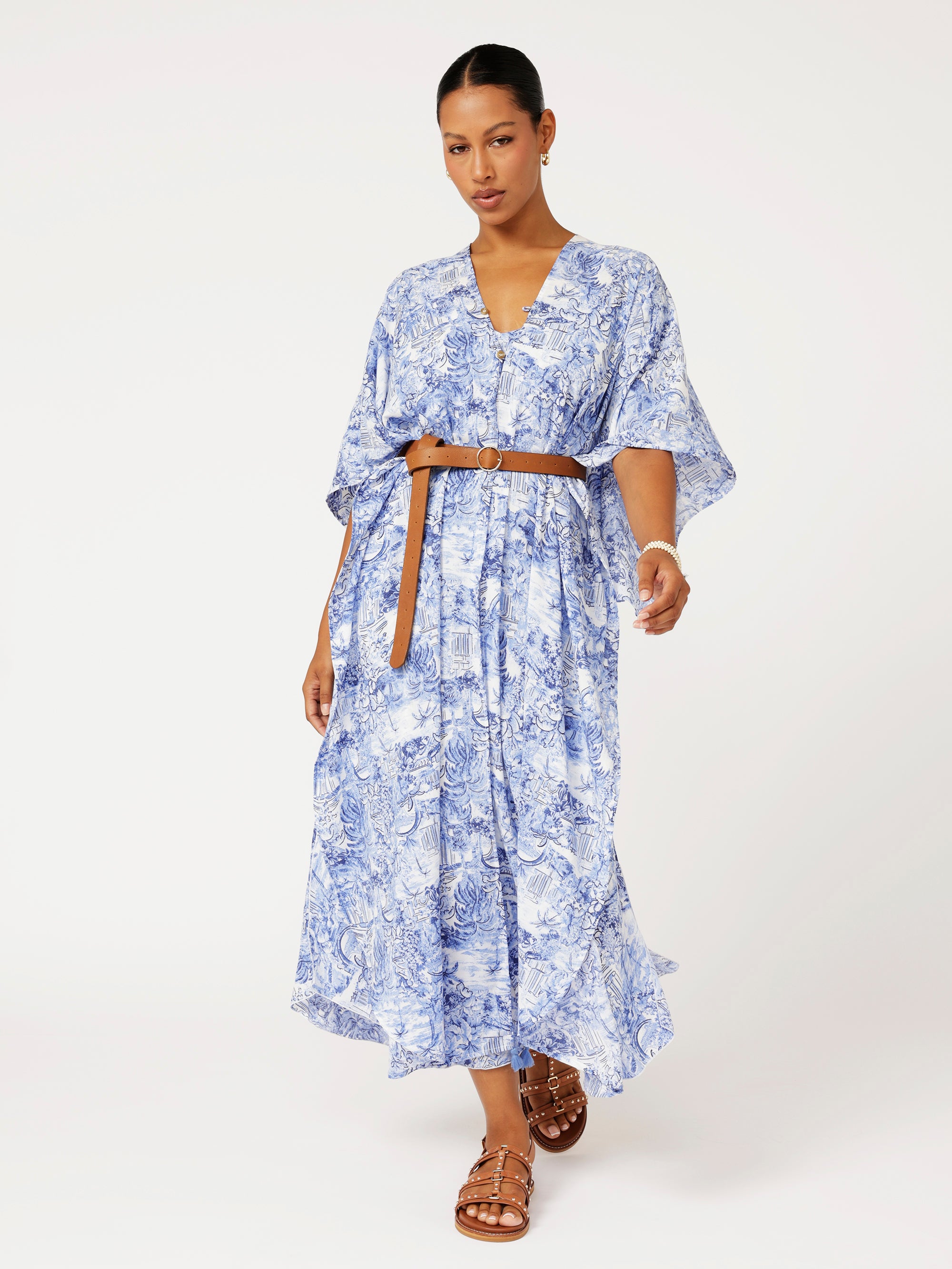 Soiree Wrap in blue Toile de Jouy print styled with belt for chic resort wear and summer event look.