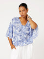 Front view of model wearing the Thalia Top in blue Toile de Jouy rayon print