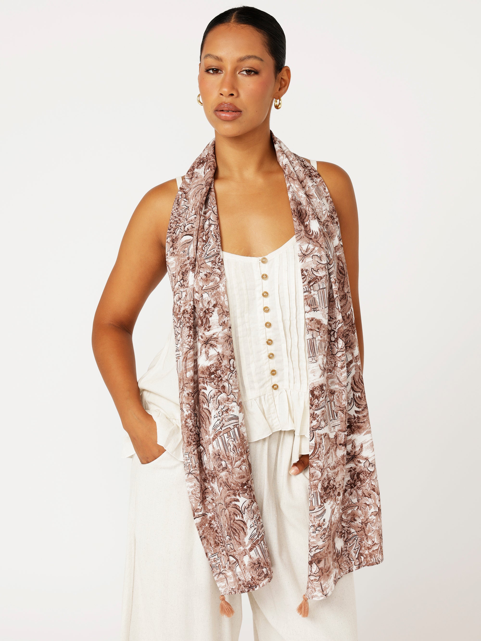 Front view of brown Toile de Jouy rayon scarf draped loosely over shoulders for relaxed resort look
