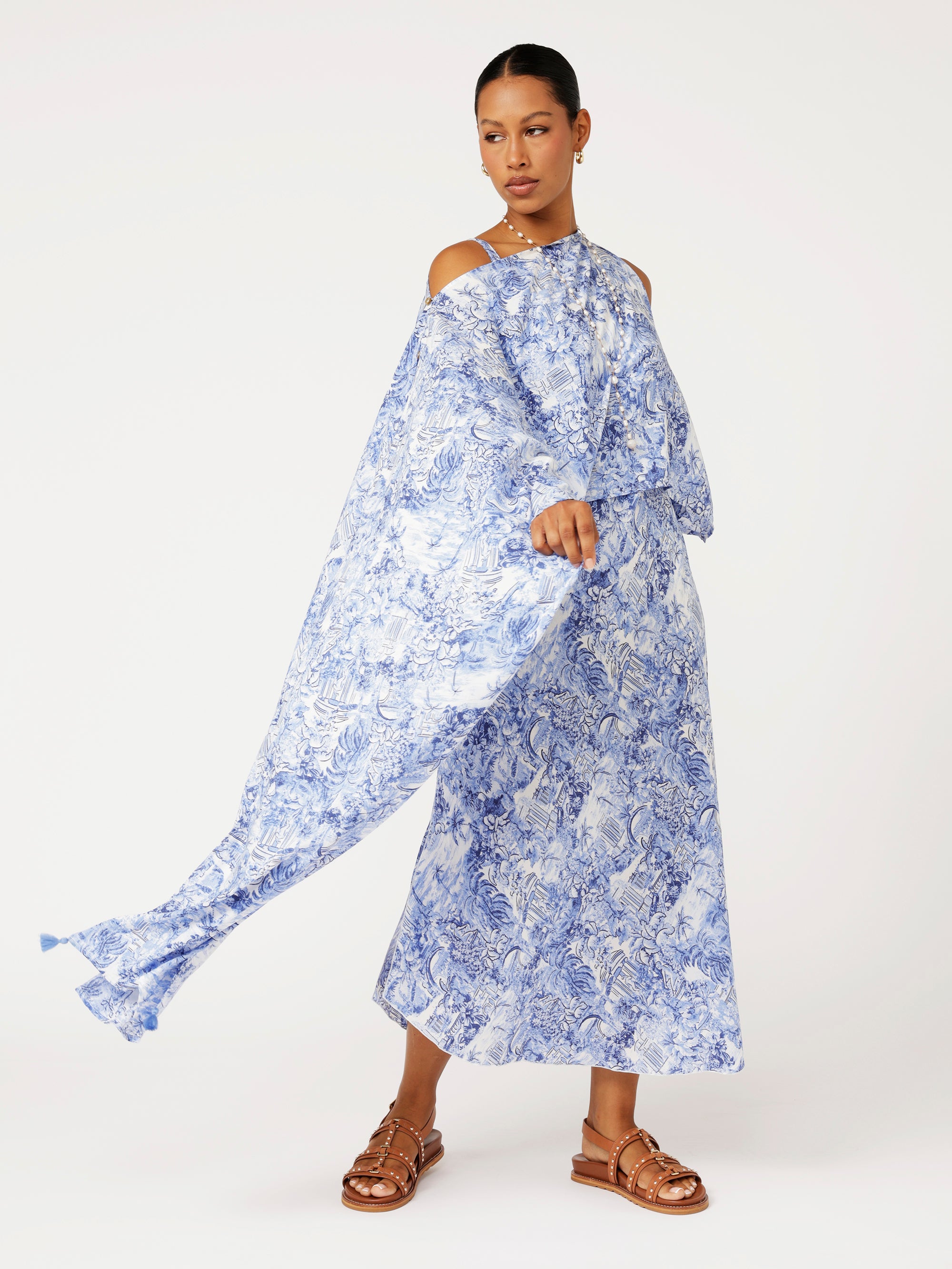 Front view of model wearing Soiree Wrap in blue Toile de Jouy rayon print styled over matching Slip Dress for evening resort look.